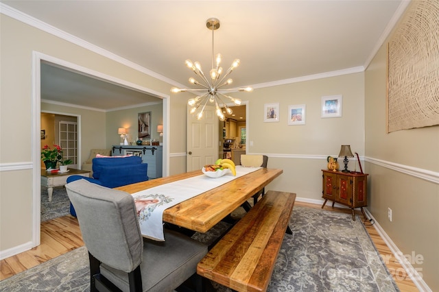 10316 Whitethorn Dr, Charlotte, NC 28277 - dining space with a notable chandelier, baseboards, light wood-style floors, and ornamental molding
