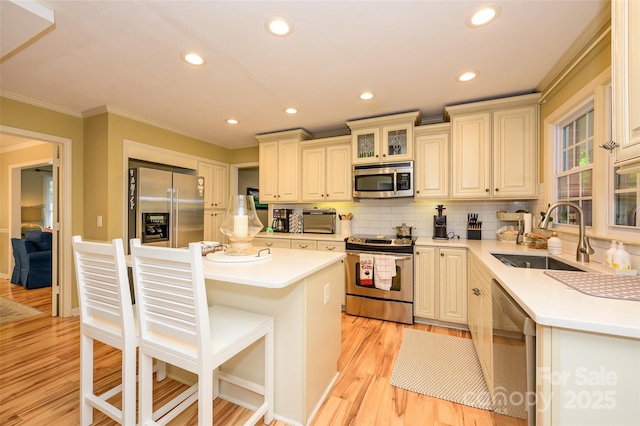 10316 Whitethorn Dr, Charlotte, NC 28277 - kitchen featuring a sink, crown molding, a center island, appliances with stainless steel finishes, and a breakfast bar area