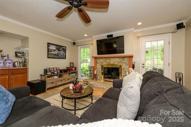 10316 Whitethorn Dr, Charlotte, NC 28277 - living area featuring light wood-style flooring, recessed lighting, a ceiling fan, crown molding, and a stone fireplace