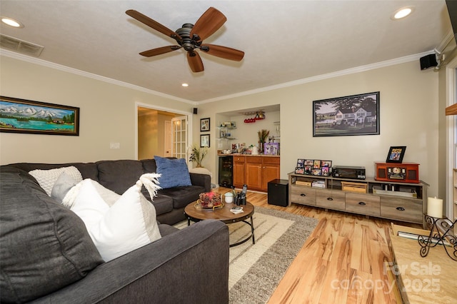 10316 Whitethorn Dr, Charlotte, NC 28277 - living area featuring a ceiling fan, visible vents, light wood-style floors, and ornamental molding