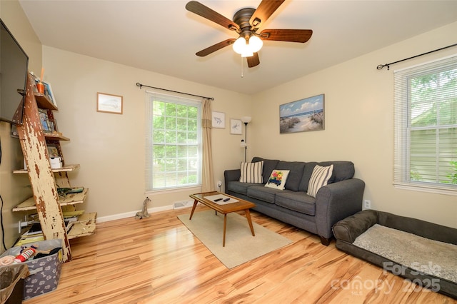 10316 Whitethorn Dr, Charlotte, NC 28277 - living room with light wood finished floors, baseboards, visible vents, and ceiling fan