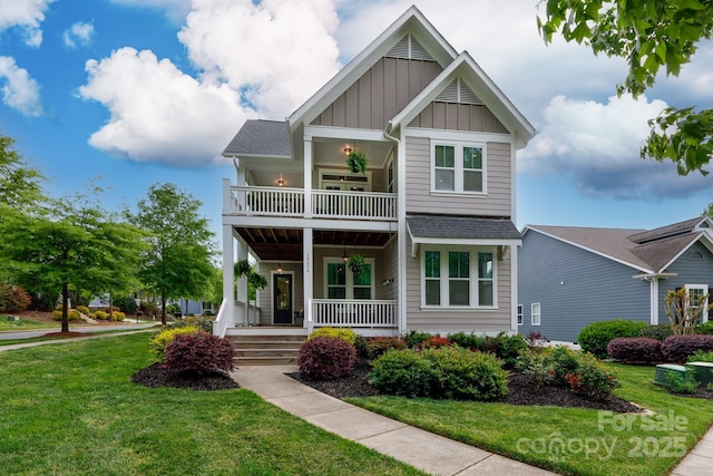 19034 Cypress Garden Dr, Davidson, NC 28036 - craftsman-style house featuring a balcony, board and batten siding, a front lawn, a porch, and a shingled roof