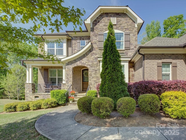 712 Chase Ct, Fort Mill, SC 29708 - traditional-style home with stone siding and covered porch