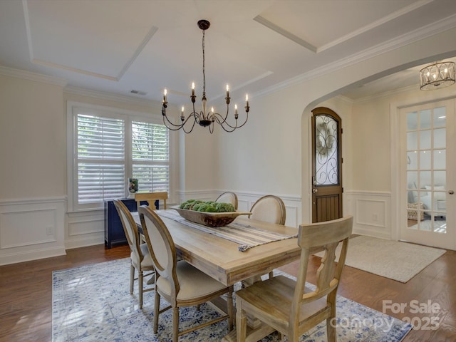 712 Chase Ct, Fort Mill, SC 29708 - dining space with arched walkways, wood finished floors, a notable chandelier, and wainscoting