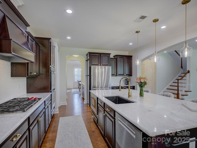 712 Chase Ct, Fort Mill, SC 29708 - kitchen with custom exhaust hood, a sink, arched walkways, stainless steel appliances, and visible vents