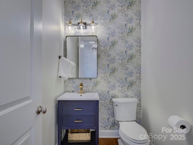 712 Chase Ct, Fort Mill, SC 29708 - bathroom with wallpapered walls, wood finished floors, toilet, vanity, and baseboards