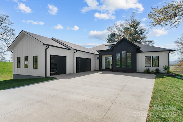 503 Nesbitt Dr, Mills River, NC 28759 - modern inspired farmhouse featuring an attached garage, driveway, board and batten siding, a shingled roof, and a front lawn
