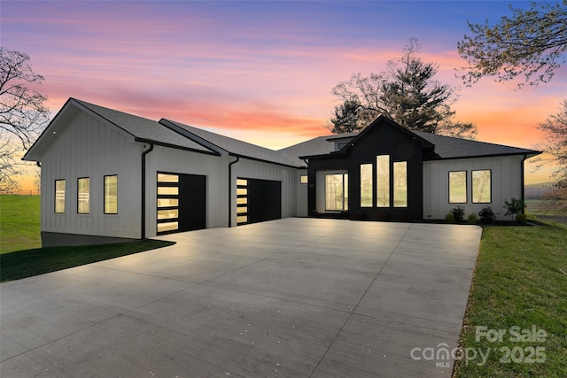 503 Nesbitt Dr, Mills River, NC 28759 - modern farmhouse style home with a garage, concrete driveway, board and batten siding, a front yard, and roof with shingles