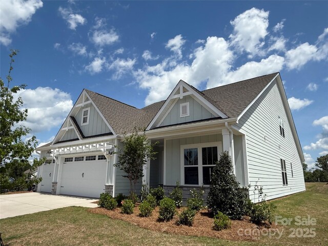 craftsman house with a garage, a shingled roof, board and batten siding, and concrete driveway