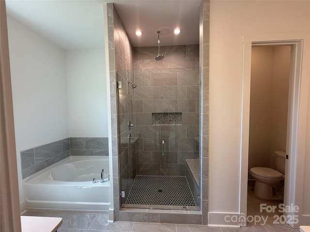 bathroom with recessed lighting, a stall shower, toilet, and a garden tub