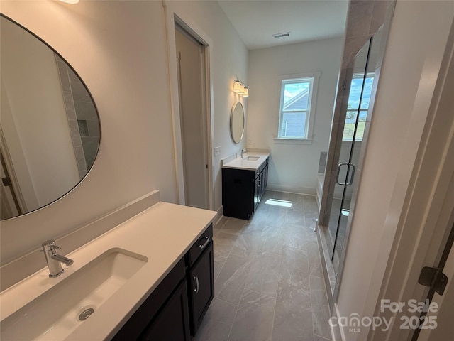 full bath with visible vents, a shower stall, a sink, and marble finish floor
