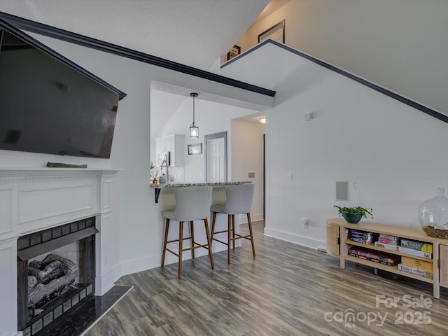1488 Meadow Glen Ln, Rock Hill, SC 29730 - living area featuring dark wood-style floors, a fireplace with flush hearth, baseboards, and lofted ceiling