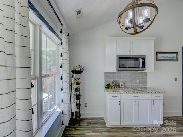1488 Meadow Glen Ln, Rock Hill, SC 29730 - kitchen featuring stainless steel microwave, vaulted ceiling, decorative backsplash, dark wood-type flooring, and a chandelier