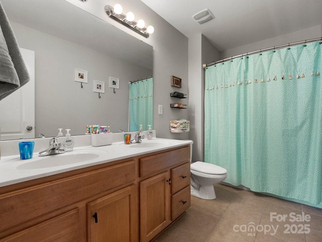 full bath with toilet, tile patterned flooring, a sink, and double vanity