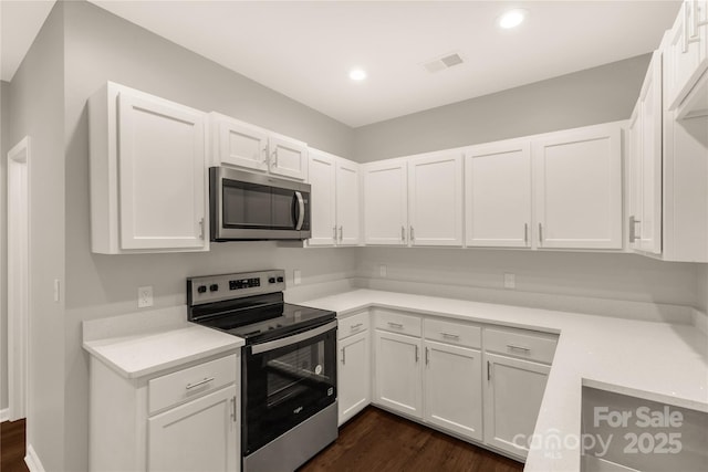 119 Washington St, York, SC 29745 - kitchen featuring appliances with stainless steel finishes, white cabinetry, dark wood finished floors, light countertops, and recessed lighting