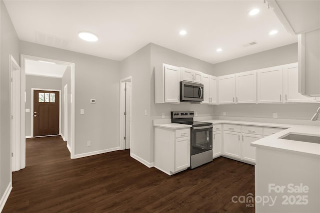 119 Washington St, York, SC 29745 - kitchen with appliances with stainless steel finishes, a sink, dark wood-type flooring, baseboards, and recessed lighting