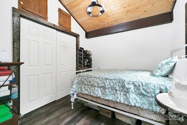 bedroom featuring lofted ceiling, wooden ceiling, dark wood-style floors, and a closet