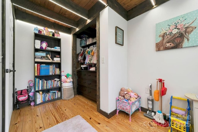 interior space with beamed ceiling, wood finished floors, and wood ceiling
