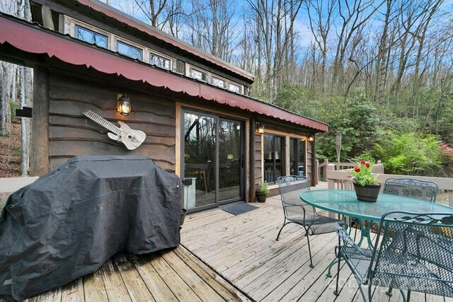 deck featuring outdoor dining space and area for grilling