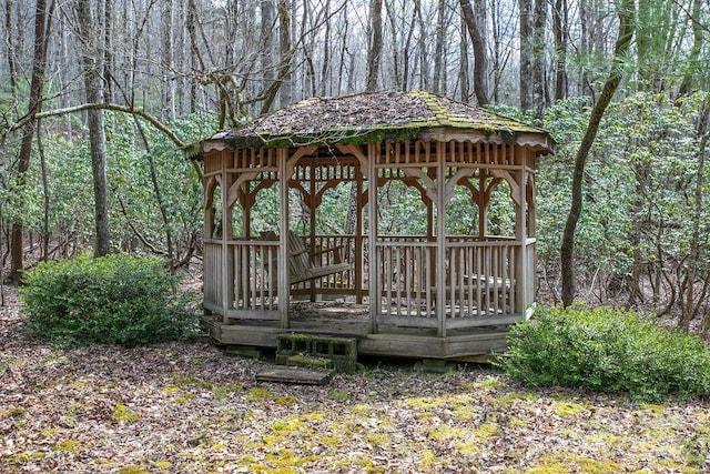 view of property's community with a gazebo and a forest view