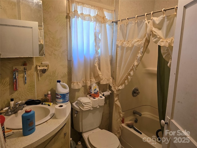 bathroom featuring toilet, shower / tub combo with curtain, vanity, and wallpapered walls