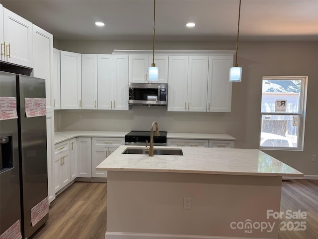 122 39th Avenue Ct NW, Hickory, NC 28601 - kitchen featuring stainless steel appliances, wood finished floors, a sink, pendant lighting, and a kitchen island with sink