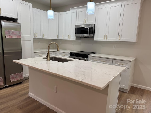 122 39th Avenue Ct NW, Hickory, NC 28601 - kitchen with stainless steel appliances, a sink, baseboards, wood finished floors, and white cabinetry