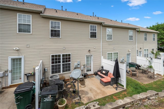rear view of property with a patio and fence