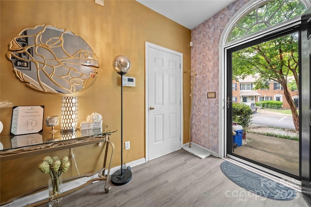 foyer featuring wood finished floors and baseboards