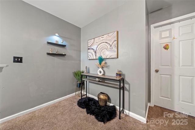 hall with carpet floors and baseboards