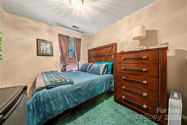 bedroom with visible vents and carpet