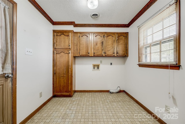 washroom featuring visible vents, ornamental molding, a textured ceiling, cabinet space, and hookup for an electric dryer