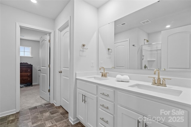 full bathroom with a shower stall, a sink, and visible vents