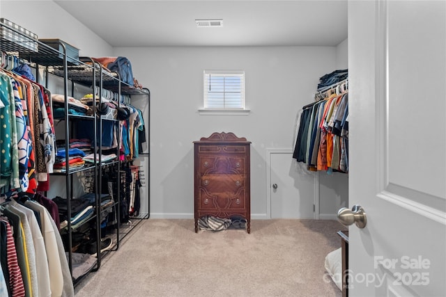 spacious closet with visible vents and carpet