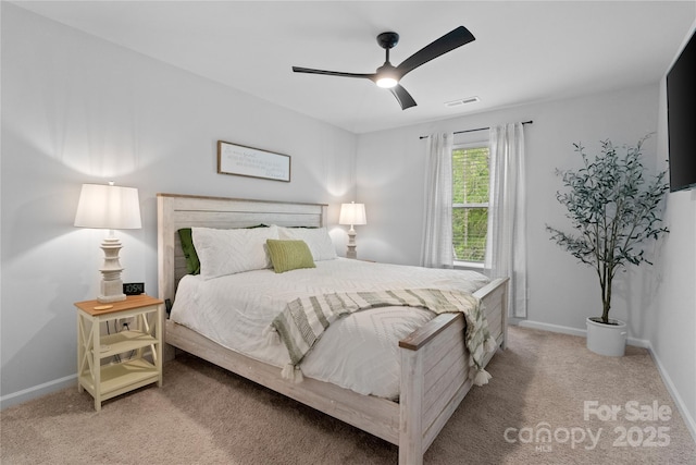 bedroom featuring ceiling fan, visible vents, baseboards, and light carpet