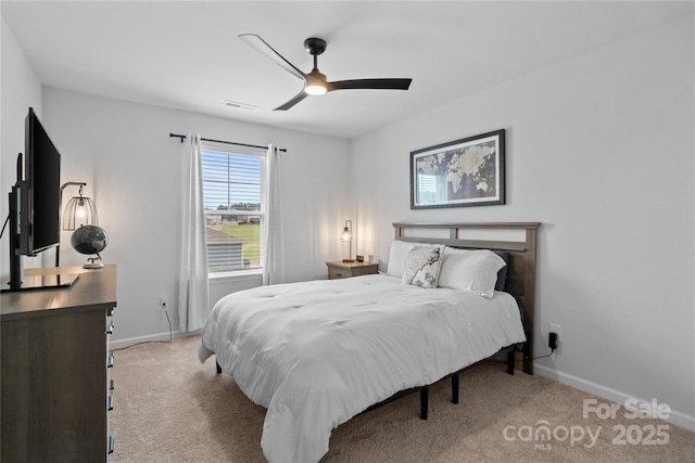 carpeted bedroom featuring baseboards, a ceiling fan, and visible vents