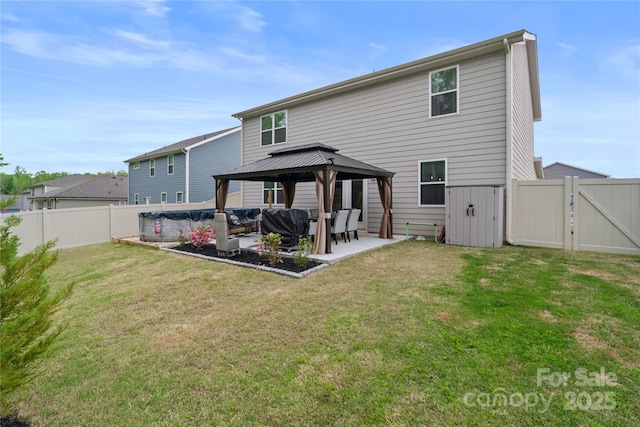 back of house with a gazebo, a fenced backyard, a patio, and a gate