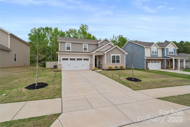 view of front of home with concrete driveway, a front lawn, board and batten siding, an attached garage, and brick siding