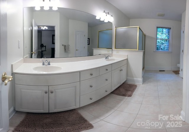 9600 Lockhorn Ct, Mint Hill, NC 28227 - bathroom featuring toilet, double vanity, a stall shower, tile patterned flooring, and baseboards