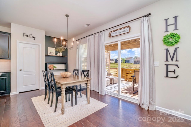 17231 Rider Wood Ln, Charlotte, NC 28278 - dining space featuring a chandelier, dark wood finished floors, and baseboards