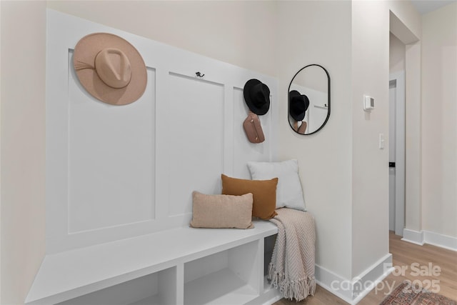 mudroom with wood finished floors and baseboards