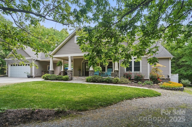craftsman house with a shingled roof, a front lawn, driveway, covered porch, and a garage