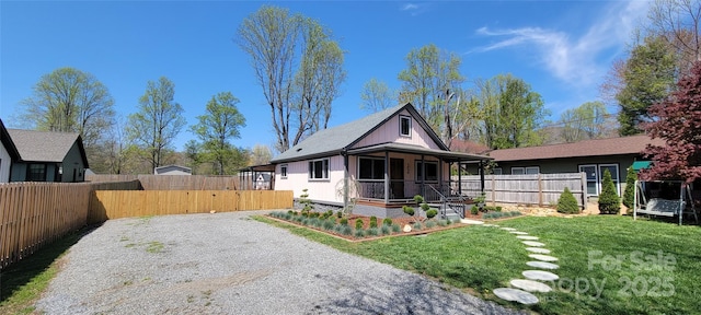 219 Flat Creek Rd, Black Mountain, NC 28711 - view of front of home with a porch, driveway, a front yard, and fence