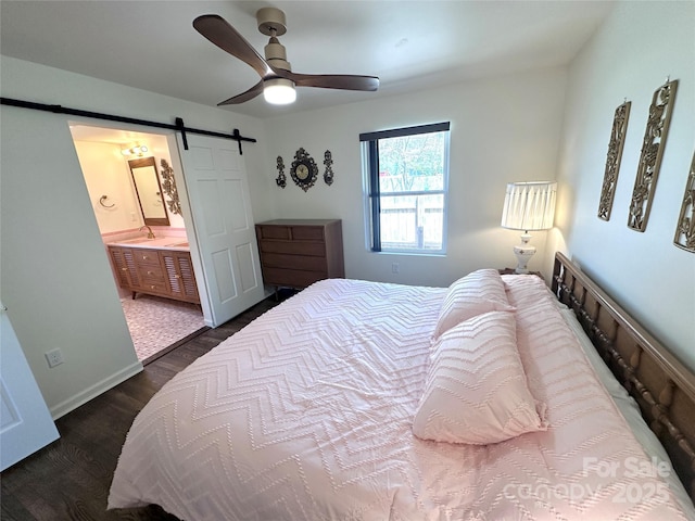 219 Flat Creek Rd, Black Mountain, NC 28711 - bedroom featuring baseboards, ensuite bathroom, dark wood-type flooring, a barn door, and ceiling fan