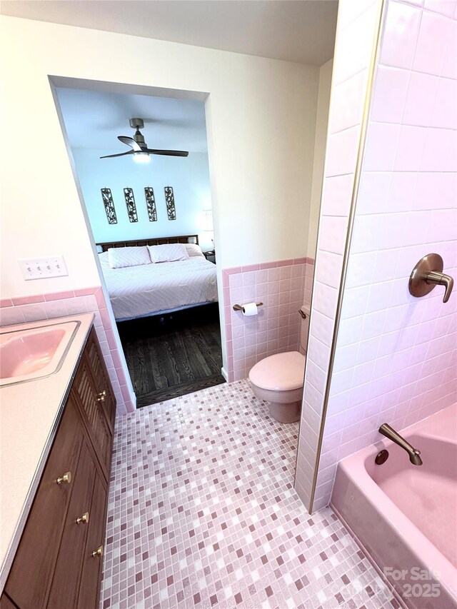 219 Flat Creek Rd, Black Mountain, NC 28711 - full bath featuring tile patterned flooring, ensuite bathroom, toilet, ceiling fan, and tile walls