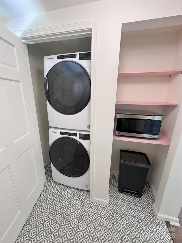219 Flat Creek Rd, Black Mountain, NC 28711 - washroom with tile patterned flooring, stacked washer / dryer, baseboards, and laundry area