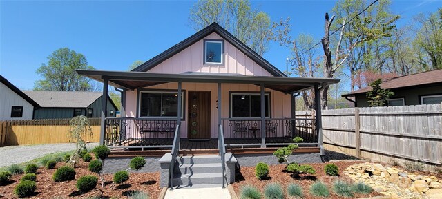 219 Flat Creek Rd, Black Mountain, NC 28711 - bungalow featuring board and batten siding, a porch, and fence