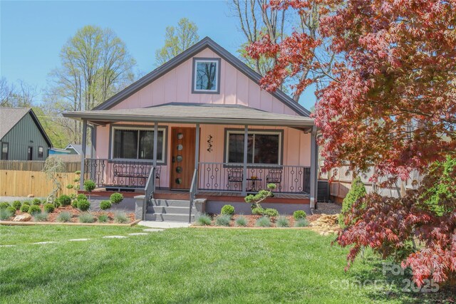 219 Flat Creek Rd, Black Mountain, NC 28711 - bungalow-style house with fence, a front lawn, and covered porch