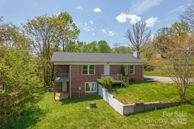 963 Kenham Pl SW, Lenoir, NC 28645 - bi-level home with brick siding, a front yard, and a chimney