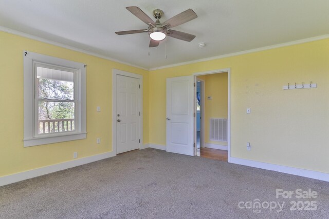 963 Kenham Pl SW, Lenoir, NC 28645 - empty room featuring visible vents, baseboards, a ceiling fan, carpet, and crown molding